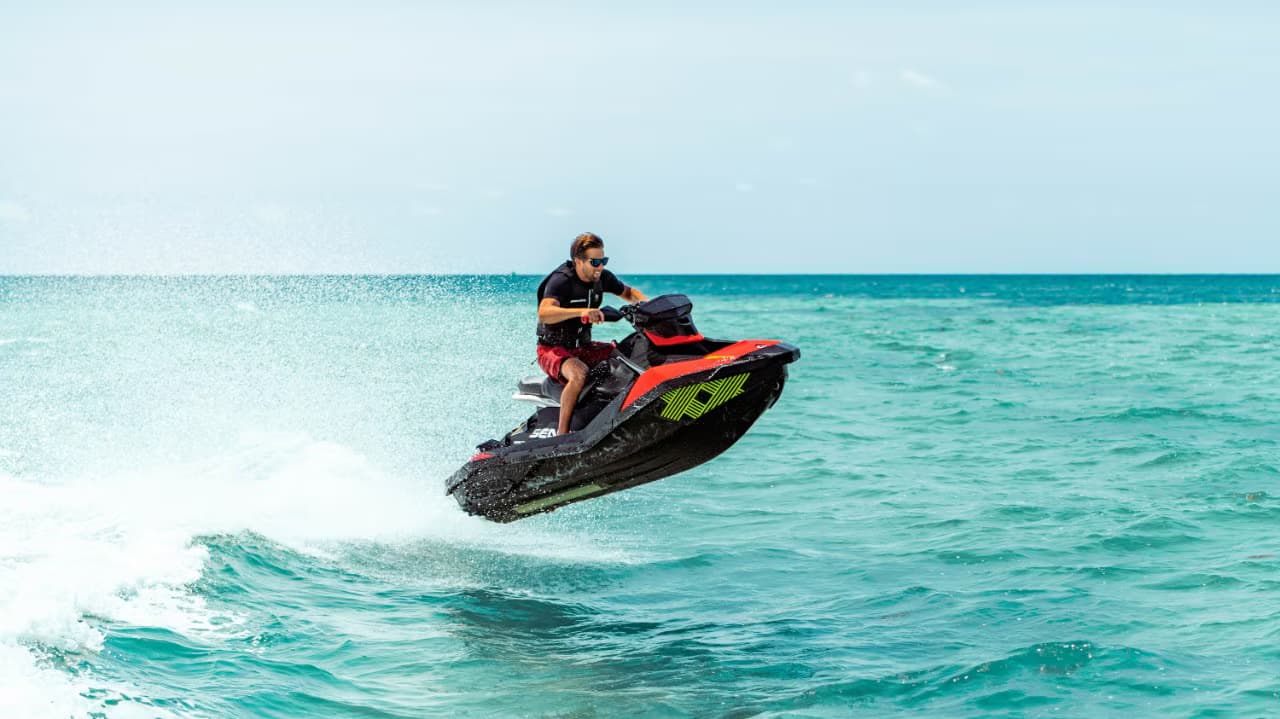 Jet skis and riders on the water